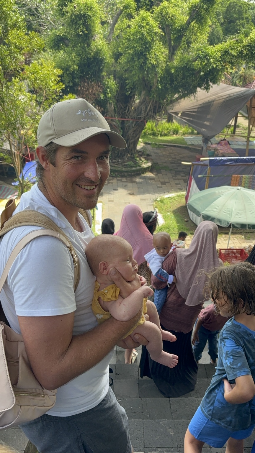 Greg carrying baby Paloma while exploring with the family