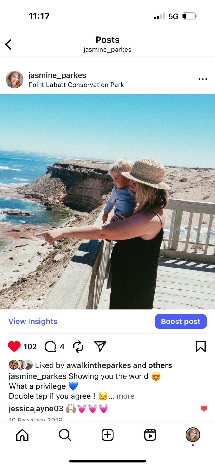 Jaz holding Sutton and pointing out the coastal view